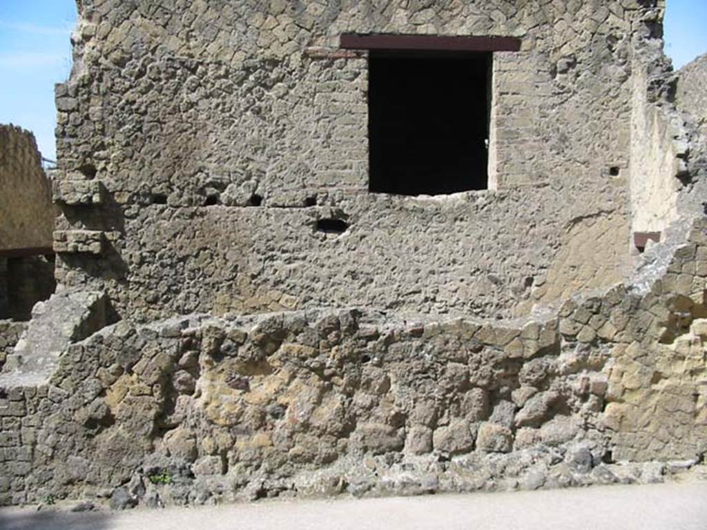 IV.11, Herculaneum, May 2003. Looking towards exterior wall on south side of Decumanus Inferiore, on east side of entrance doorway, on right. The large window would have given light to the large triclinium, from a corridor with latrine. Photo courtesy of Nicolas Monteix.